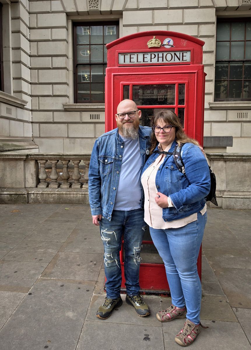 Carlton and Ashley in front of a red London phone box